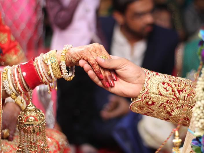 Newlywed Couple Holding Hands In Wedding Ceremony in India