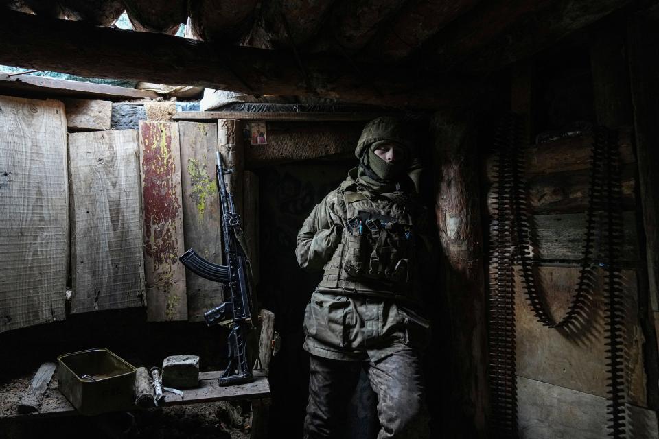 A Ukrainian serviceman stands in a shelter on a position at the line of separation between Ukraine-held territory and rebel-held territory near Zolote, Ukraine, on Feb. 19, 2022.