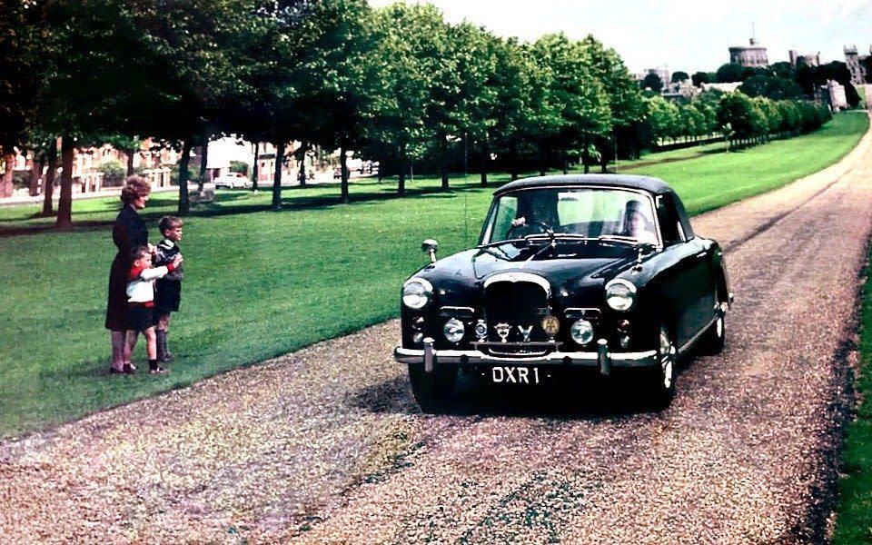 The Duke of Edinburgh drives with Queen Elizabeth II through Windsor Castle in his Alvis Car OXR 1