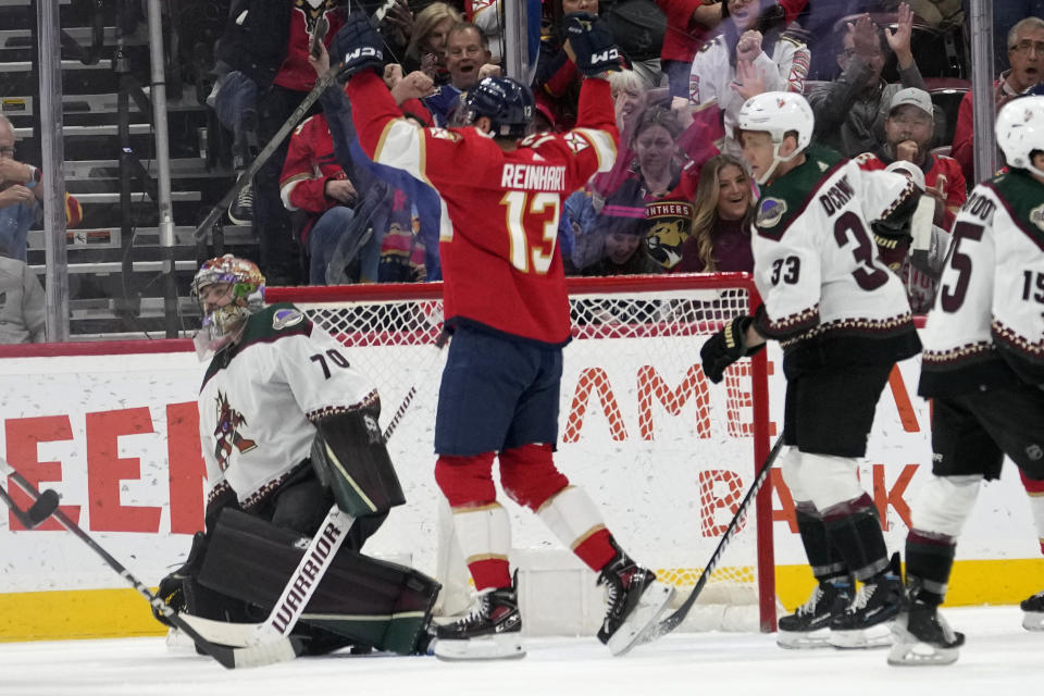 Florida Panthers center Sam Reinhart (13) reacts after scoring goal against Arizona Coyotes goaltender Karel Vejmelka (70) during the first period of an NHL hockey game Wednesday, Jan. 24, 2024, in Sunrise, Fla. (AP Photo/Lynne Sladky)