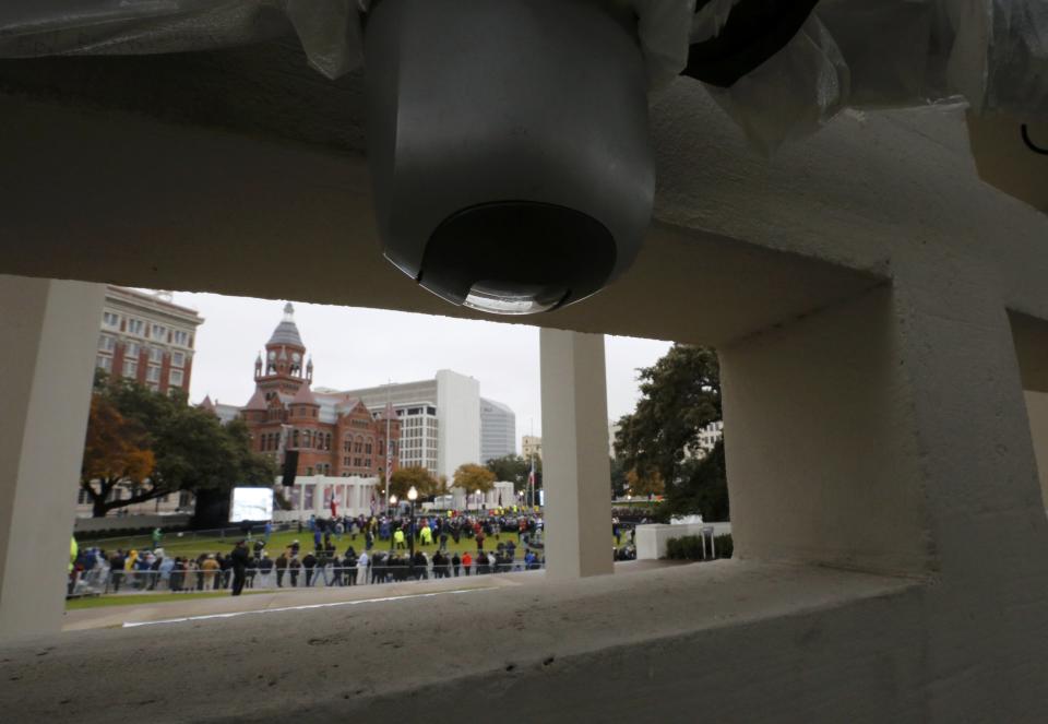 A video camera atop Dealey Plaza's "grassy knoll," watches as crowds gather for 50th anniversary ceremonies of JFK's assassination in Dallas