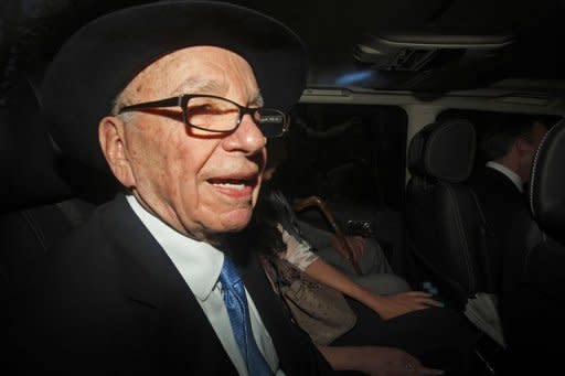 Rupert Murdoch is driven away from the High Court in central London on April 26, 2012. Murdoch's embattled media giant News Corp posted a net loss of $1.51 billion in its fiscal fourth quarter Wednesday, as the firm prepared for a major restructuring