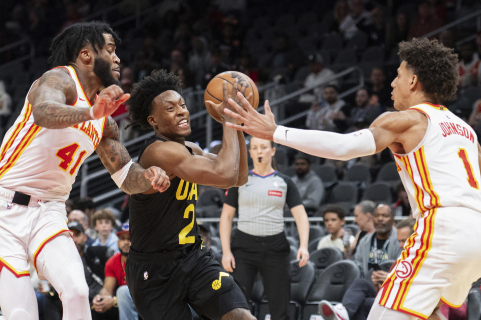 Utah Jazz guard Collin Sexton (2) drives to the basket against Atlanta Hawks forward Saddiq Bey (41) and forward Jalen Johnson (1) during the first half of an NBA basketball game Tuesday, Feb. 27, 2024, in Atlanta. (AP Photo/Hakim Wright Sr.)