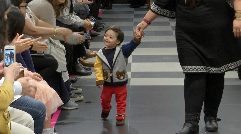 This image from video taken on Wednesday, Oct. 16, 2019 shows a young boy participating in the 2nd annual “Gigi’s Playhouse Fashion Show” in New York. Gigi’s Playhouse is an education and achievement center that prepares young people with Down syndrome to engage more fully in their homes, schools and communities. (AP Photo/Gary Gerard Hamilton)