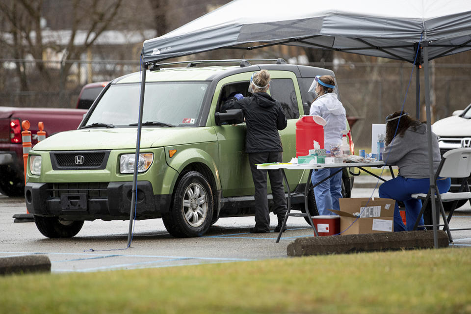 The Wayne County Health Department administers COVID-19 vaccines for anyone 80 years of age or older at a drive-thru site on Thursday, Dec. 31, 2020, in Wayne, W.Va. (Sholten Singer/The Herald-Dispatch via AP)