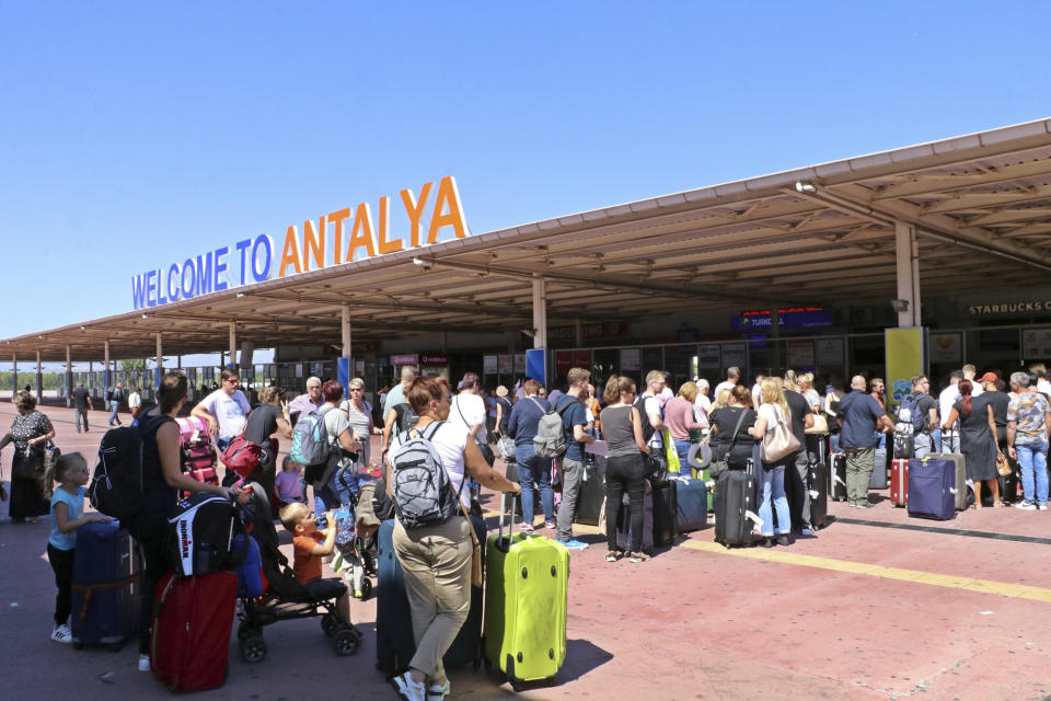 British passengers with Thomas Cook wait in long queue at Antalya airport in Antalya, Turkey, Monday Sept. 23, 2019. Hundreds of thousands of travellers were stranded across the world Monday after British tour company Thomas Cook collapsed, immediately halting almost all its flights and hotel services and laying off all its employees. According to reports Monday morning some 21,000 Thomas Cook travellers were stranded in Turkey alone.(IHA via AP)