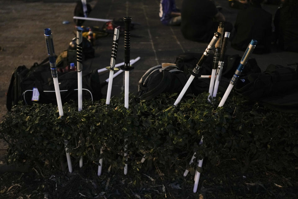 Combat lightsabers sit at a park before training by the Jedi Knight Academy in Mexico City, late Thursday, June 20, 2024. The academy is a lightsaber combat and choreography school founded in 2019 and a dream come true for fans of Star Wars. (AP Photo/Eduardo Verdugo)