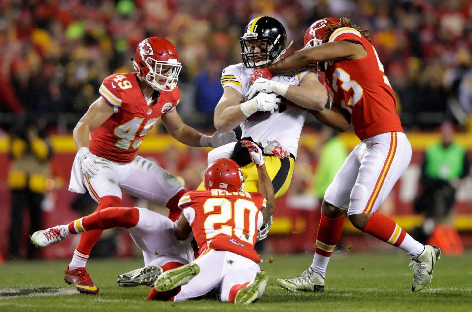 <p>Tight end Jesse James #81 of the Pittsburgh Steelers is tackled inside linebacker Ramik Wilson #53 of the Kansas City Chiefs and teammates Steven Nelson #20 and Defensive back Daniel Sorensen #49 in the AFC Divisional Playoff game at Arrowhead Stadium on January 15, 2017 in Kansas City, Missouri. (Photo by Jamie Squire/Getty Images) </p>