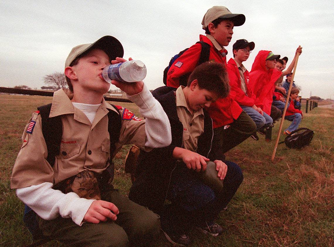 Dec. 15, 2001: Boy Scout Jeff Fruhwirt, left, takes a drink of water while Robert Cayou opens his canteen, as members of Troop 351 take a break on the hike to their new meeting place. Johnathan Olmos, James Trotchie and Josh Ordway sit on a fence behind them. The troop had grown too large for Blue Mound Lion’s Club and will now meet at Lake Worth United Methodist Church. Richard W. Rodriguez/Star-Telegram