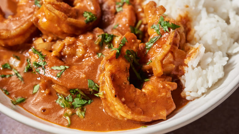 shrimp tikka masala in white bowl with rice