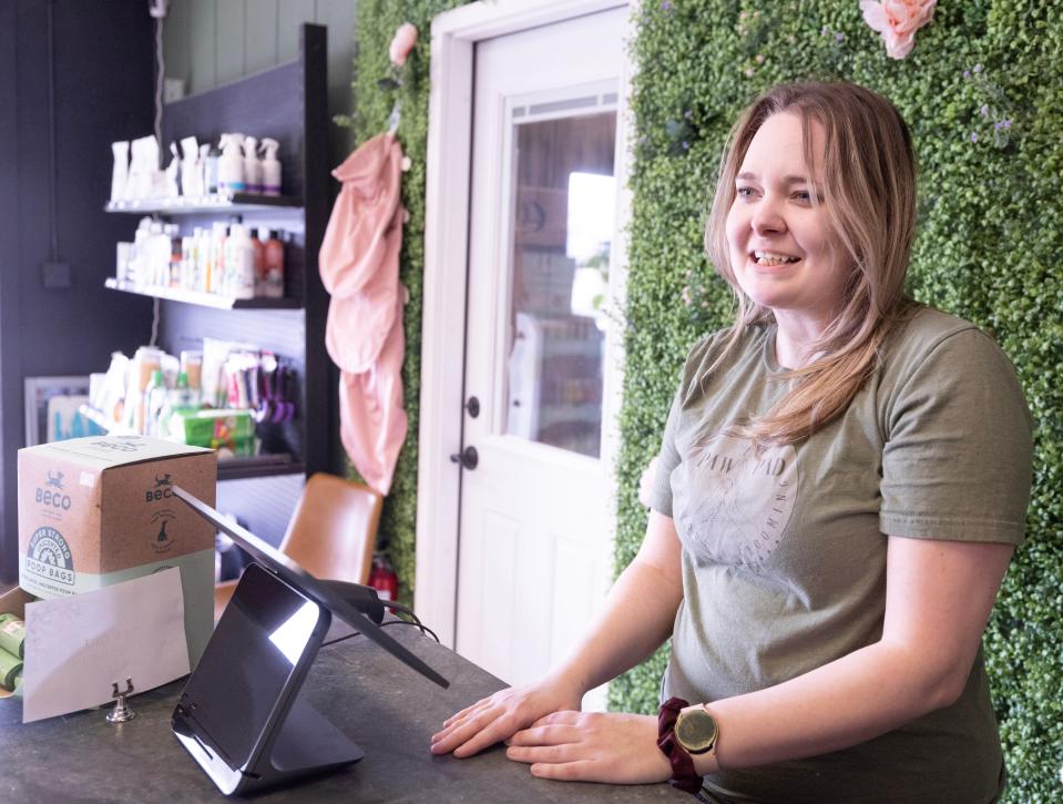 Tara Myer, owner of the Paw Pad, talks about business at the Lake Cable Shopping Center in Jackson Township.