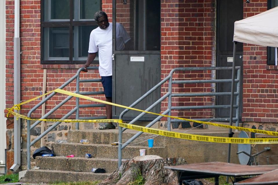 A person looks out at the scene of the mass shooting (Copyright 2023 The Associated Press. All rights reserved)