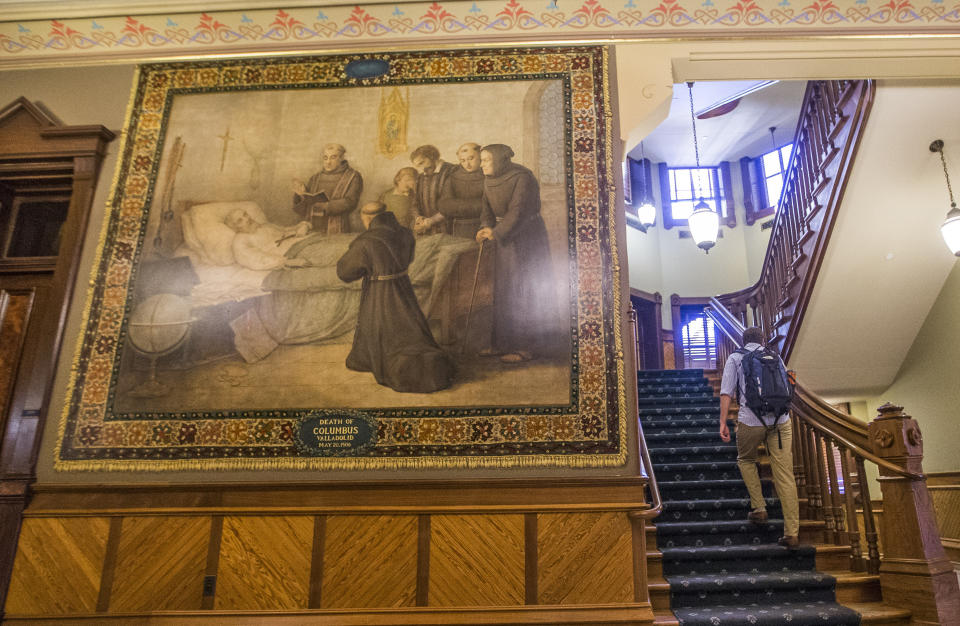 This Nov. 29, 2017, photo shows a murals of Christopher Columbus at Notre Dame in South Bend, Ind. The University of Notre Dame will cover murals in a campus building that depict Christopher Columbus in America, the school's president said, following criticism that the images depict Native Americans in stereotypical submissive poses before white European explorers. (Robert Franklin/South Bend Tribune via AP)