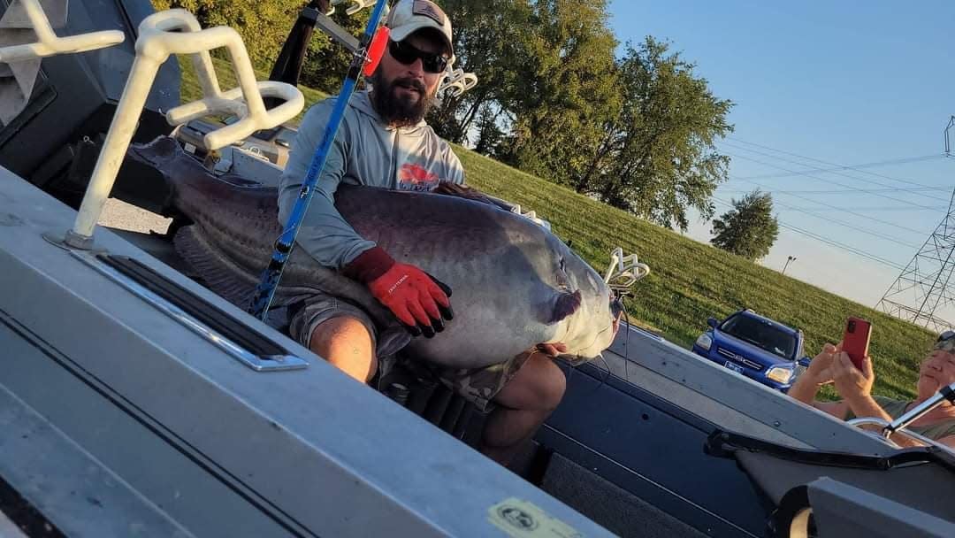 Micka Burkhart holds a 118-pound, 54-inch blue catfish that he caught in the Cumberland River on Saturday.