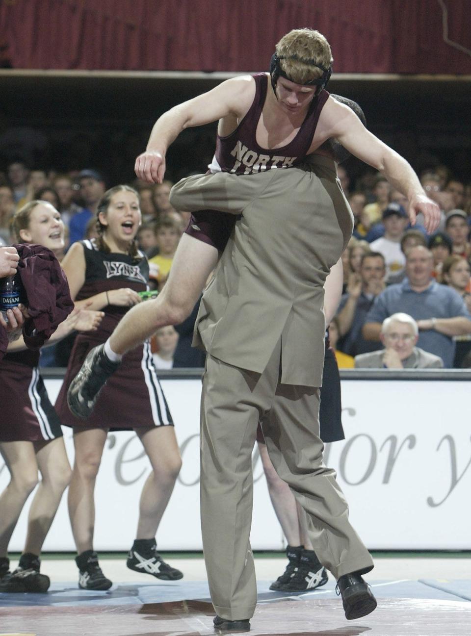 Jay Borschel gets some help in celebrating title No. 4 in 2005 at Veterans Memorial Auditorium. He spent a season at Virginia Tech before transferring to the University of Iowa.