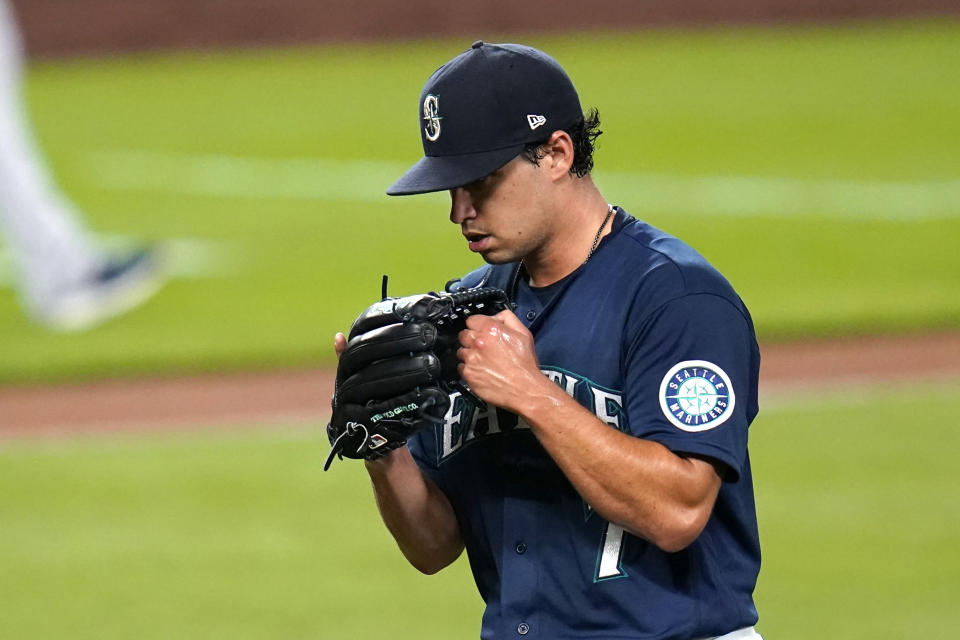 Seattle Mariners starting pitcher Marco Gonzales pounds his glove as he heads off the field in the sixth inning of a baseball game against the Houston Astros, Monday, Sept. 21, 2020, in Seattle. (AP Photo/Elaine Thompson)