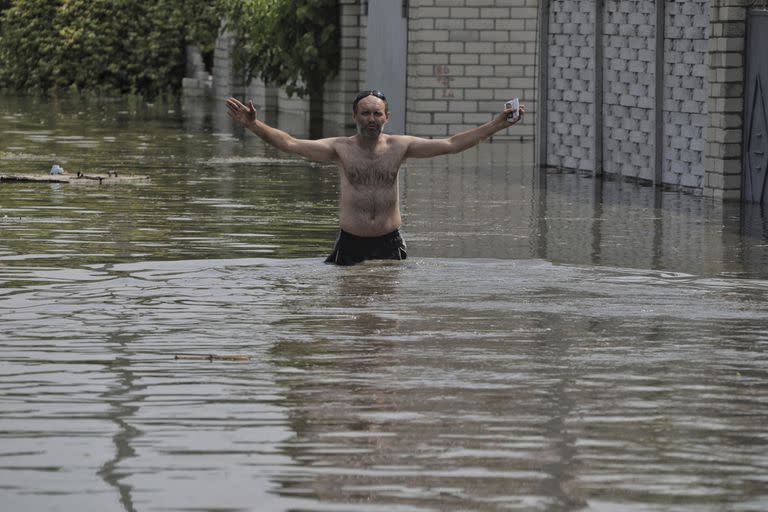 Un residente local hace un gesto cerca de su casa, que se inundó después de que las tropas rusas volaran la represa Kakhovka durante la noche, en Kherson, Ucrania, el martes 6 de junio de 2023. 