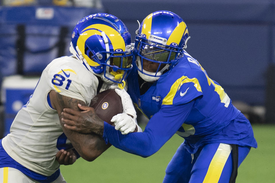 Los Angeles Rams cornerback Jalen Ramsey, right, tackles tight end Gerald Everett during NFL football practice Saturday, Aug. 22, 2020, in Inglewood, Calif. The Rams held their first practice at their new stadium. (AP Photo/Kyusung Gong)