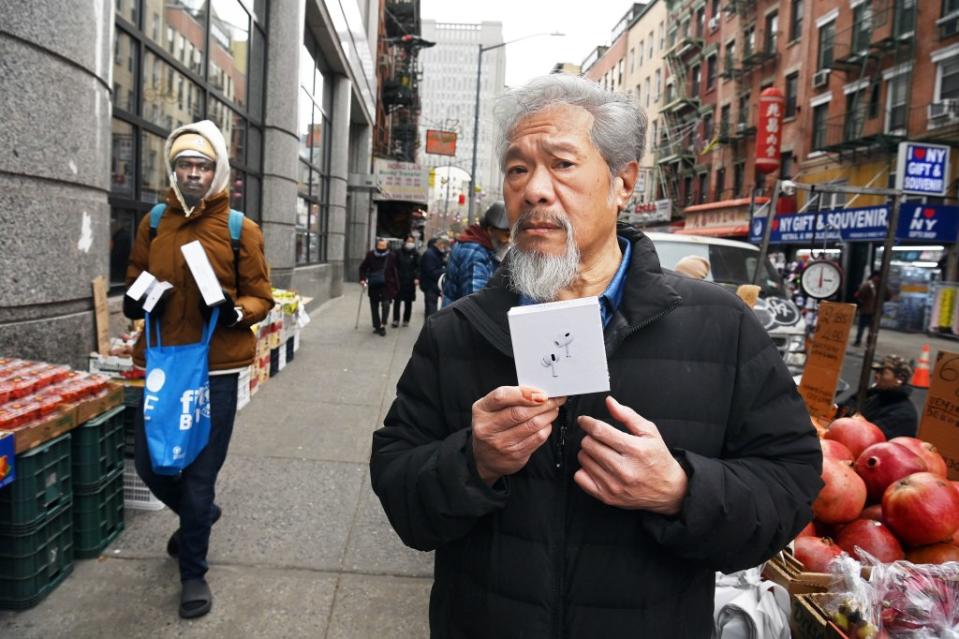Chan holds up a box of fake Apple AirPods Pro that the peddler said cost $100. He quickly settled for $50. Helayne Seidman