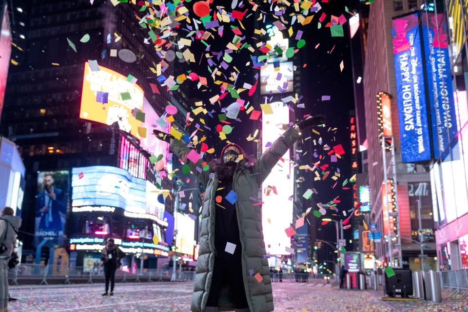 A woman throws confetti during the 2021 New Year’s Eve celebrations on January 1, 2020 in New York City.