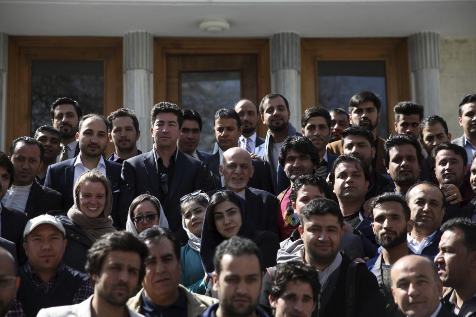 Afghan President Ashraf Ghani center, take a picture with journalists after a news conference at the presidential palace in Kabul, Afghanistan, Sunday, March, 1, 2020. Ghani said Sunday he won't be releasing the 5,000 prisoners the Taliban say must be freed before intra-Afghan negotiations can begin. (AP Photo/Rahmat Gul)