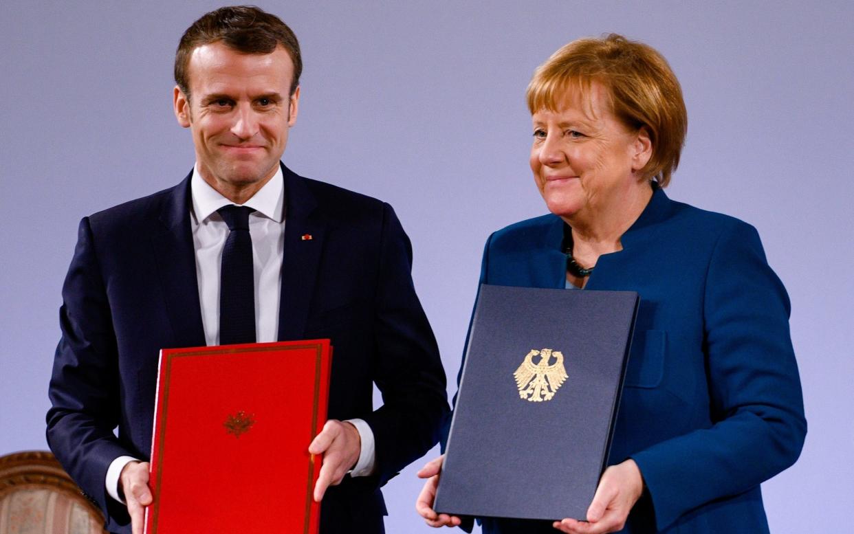 German Chancellor Angela Merkel and French President Emmanuel Macron signed the extension to the Elysee Treaty in the German border city of Aachen - Getty Images Europe