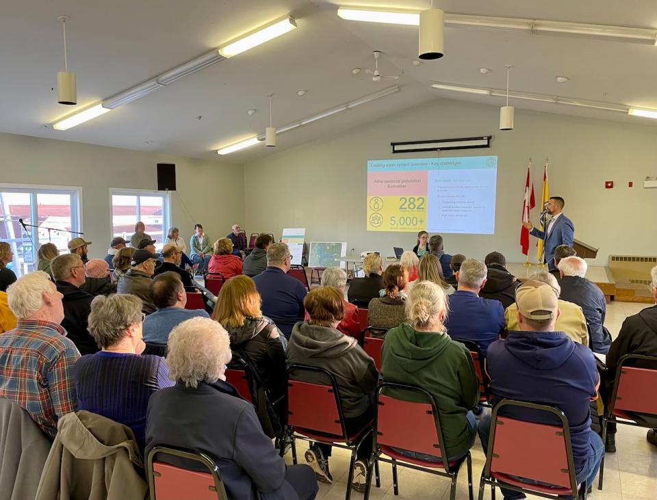 Alma residents listen to a presentation about plans to upgrade the community's water infrastructure during a public meeting on Wednesday.