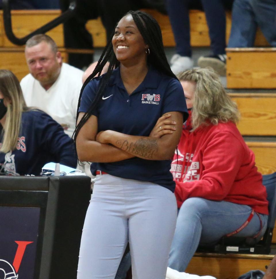 Fort Walton Beach girls basketball head coach Mercedez Claybrone smiles on the sideline during a blowout win over the Niceville Eagles.