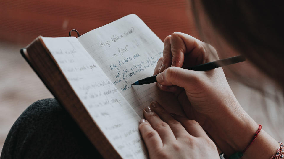 Woman writing in a notebook