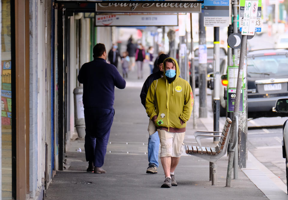 People walk along Sydney Road in Coburg, Melbourne.