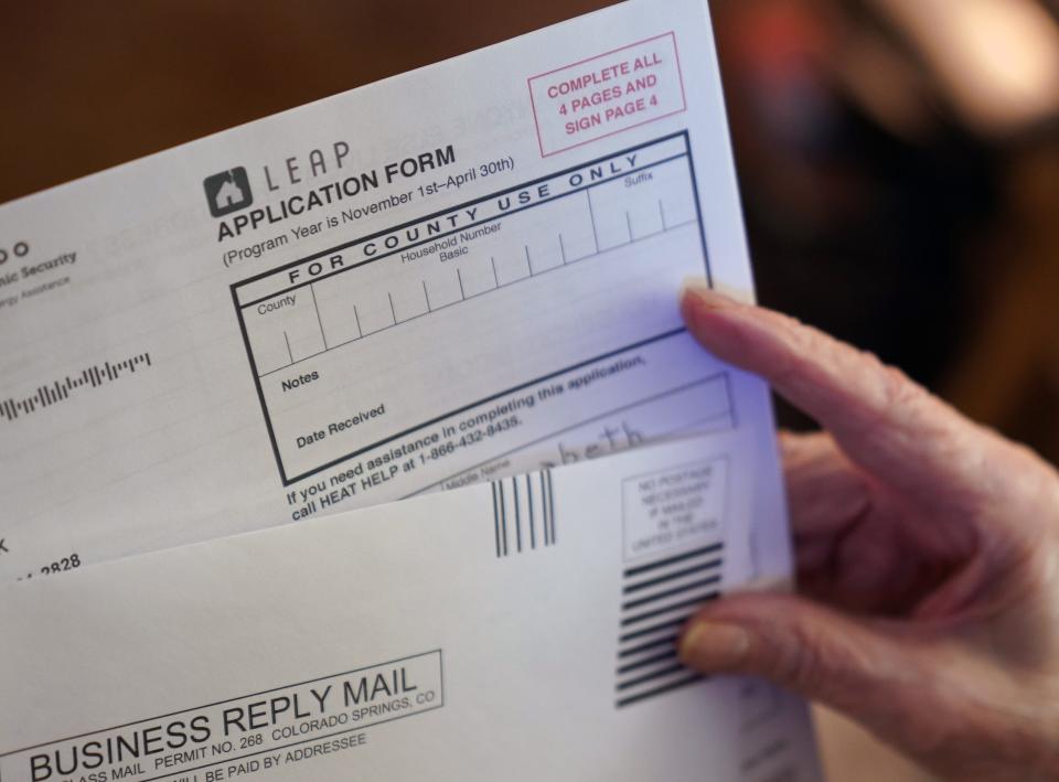 Antoinette "Toni" Stark, 99, holds an application for federally funded heating assistance, which she uses to help pay her utility bills during the cold winters in her hometown of Longmont, Colo., where she's lived since 1978.