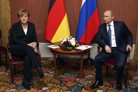 Russian President Vladimir Putin meets with German Chancellor Angela Merkel in Deauville, Northern France June 6, 2014. REUTERS/Sergei Karpukhin