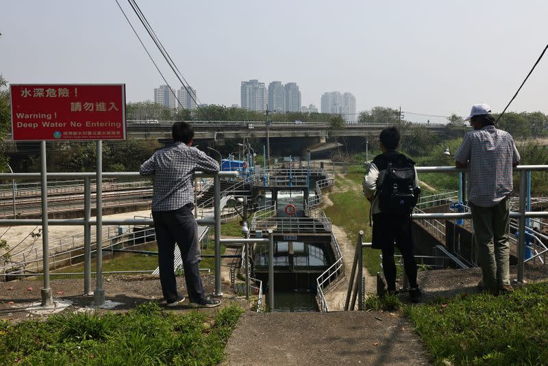 Volunteers with the Taiwan Clean Water Action Union observe a water distribution centre overlooking the city during an island-wide drought, in Hsinchu