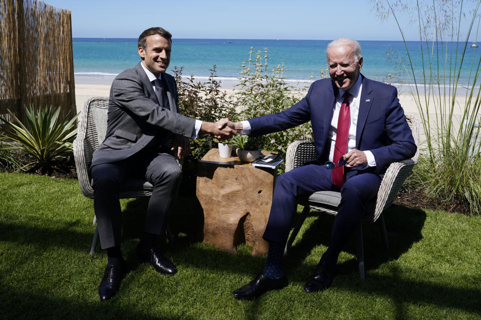 FILE - In this June 12, 2021 file photo, President Joe Biden and French President Emmanuel Macron shake hands during a bilateral meeting at the G-7 summit, in Carbis Bay, England. French President Emmanuel Macron expects "clarifications and clear commitments" from President Joe Biden in a call to be held later on Wednesday to address the submarines' dispute, Macron's office said. (AP Photo/Patrick Semansky, File)