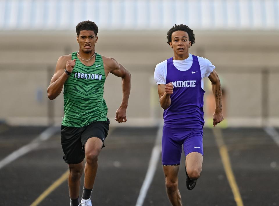 Yorktown's Quintin Williams (left) and Muncie Central's Ashton Chambers finished in third and second place, respectively, in the 200m dash in the Delta boys track and field sectional meet on Thursday, May 18, 2023.