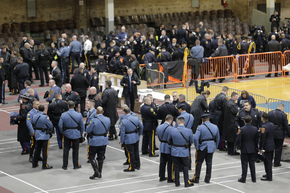Police officers and other first responders gather before the funeral of Jersey City Police Detective Joseph Seals in Jersey City, N.J., Tuesday, Dec. 17, 2019. Funeral services for Seals are scheduled for Tuesday morning. The 40-year-old married father of five was killed in a confrontation a week ago with two attackers who then drove to a kosher market and killed three people inside before dying in a lengthy shootout with police. (AP Photo/Seth Wenig)