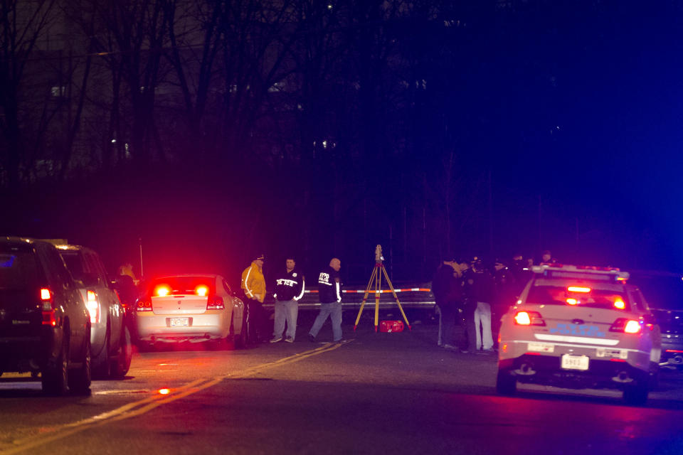 Police investigate the scene of an accident on a dead-end street where a car containing five passengers plunged into Steinway Creek in the Astoria neighborhood of Queens, Saturday, April 5, 2014, in New York. The New York Police Department says four of five people pulled from a vehicle submerged in a New York City creek have died. The fifth apparently escaped serious injury and is in stable condition. (AP Photo/John Minchillo)