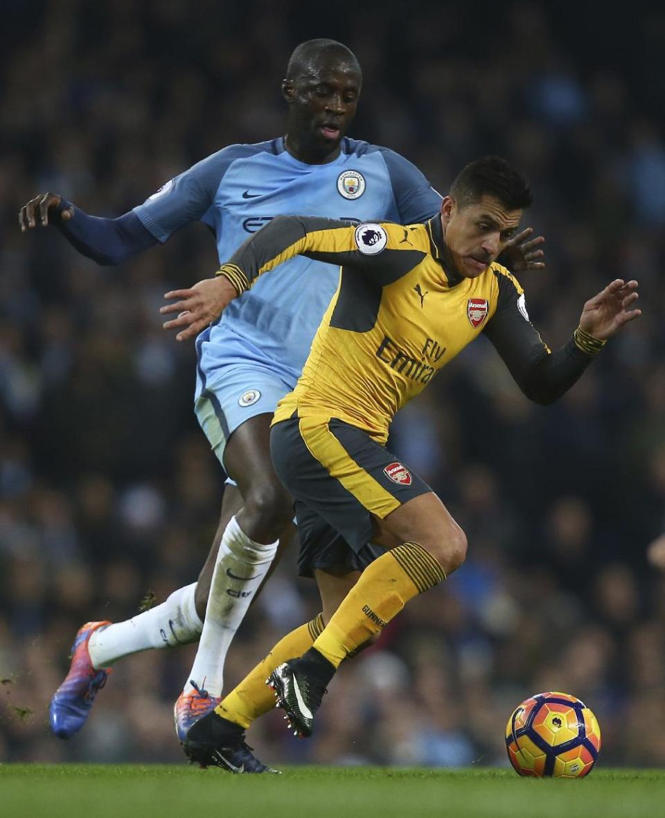 <p>Manchester City’s Yaya Toure, left, and Arsenal’s Alexis Sanchez during the English Premier League soccer match between Manchester City and Arsenal at the Etihad Stadium in Manchester, England, Sunday, Dec. 18, 2016. (AP Photo/Dave Thompson) </p>