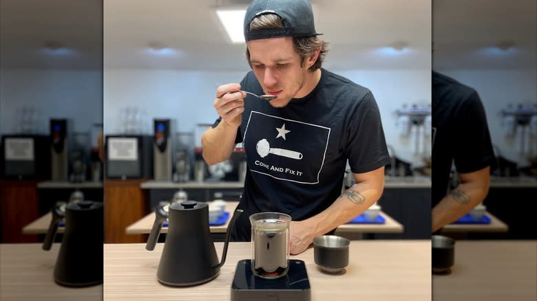 Man testing coffee with spoon