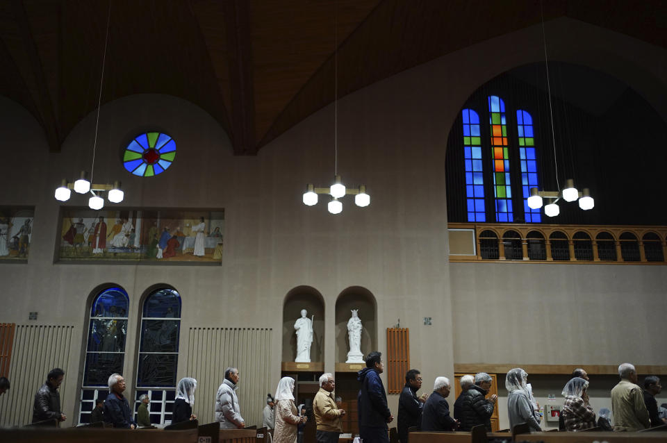 In this Nov. 17, 2019, photo, Catholics attend an early morning Mass at the Urakami Cathedral in Nagasaki, southern Japan. Pope Francis will start his first official visit to Japan in Nagasaki, ground zero for the Christian experience in a nation where the Catholic leader once dreamed of living as a missionary. (AP Photo/Eugene Hoshiko)