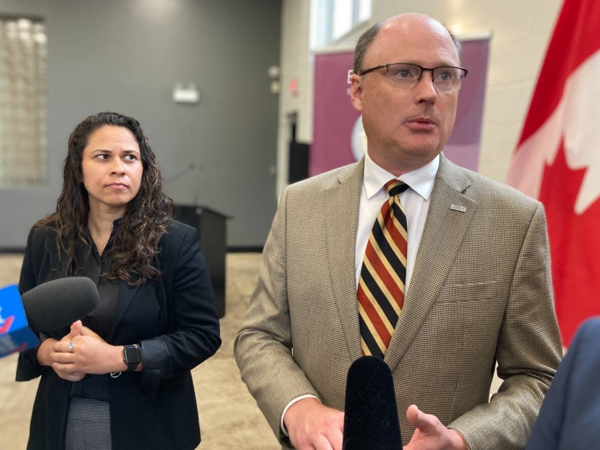 Patricia Carvalho, left, trained in the United States and hopes to be certified as a registered nurse by the end of this year. Labour Minister Trevor Holder announced an expansion to the province's Navigator program for nurses. (Jacques Poitras/CBC - image credit)