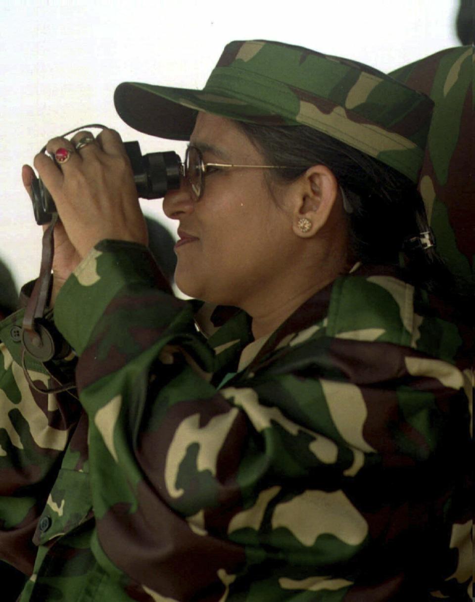 FILE- Bangladesh Prime Minister Sheikh Hasina, dressed in combat gear, watches a military training in Comilla, 85 kilometers (5 miles) south of capital Dhaka, Jan.8, 1997. The elections in Bangladesh are all about one person: Prime Minister Sheikh Hasina. Analysts predict that since the main opposition party is staying out of the Jan. 7 vote, the 76-year-old leader is practically guaranteed her fifth term in office. (AP Photo/Pavel Rahman, File)