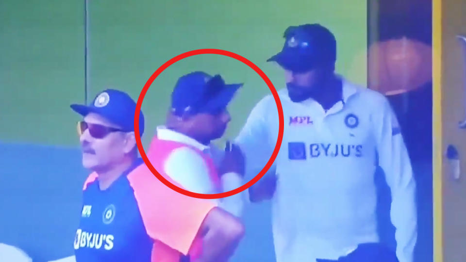 Mohammed Siraj (pictured right) grabbing Kuldeep Yadav (pictured middle) by the neck in the stands.