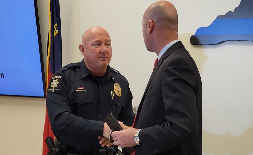 Henderson County Sheriff Lowell Griffin, left, and Henderson County Public Schools Superintendent John Bryant shake hands during Thursday's press conference at the Henderson County Sheriff's Office.