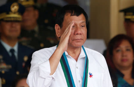 Philippine Pesident Rodrigo Duterte salutes during the change of command for the new Armed Forces chief at a military camp in Quezon city, Metro Manila, December 7, 2016. REUTERS/Erik De Castro