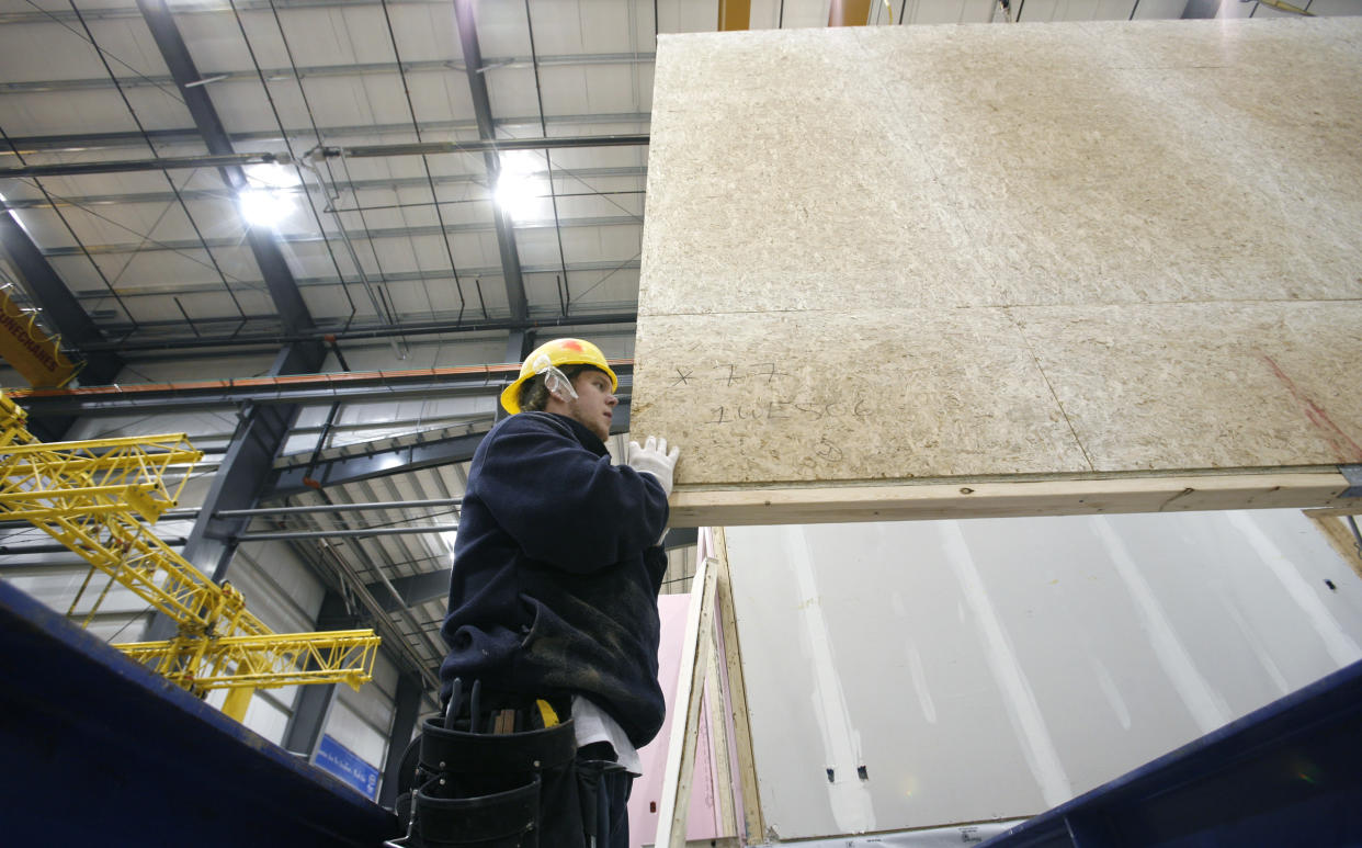 MATTAMY : January, 25, 2008: Mattamy Homes and Stellumar Advanced Manufacturing are building complete homes inside a factory in Milton. The enormous facility can accomodate the building of 9-11 homes at any given time. The homes are built from scratch and leave with tiling, carpeting, and even chandeliers swinging from the ceilings, ready to be placed on a ready lot. A worker places the wall of the garage on to the steel frame that holds the building up off the ground. (Tory Zimmerman/Toronto Star) (Photo by Tory Zimmerman/Toronto Star via Getty Images)