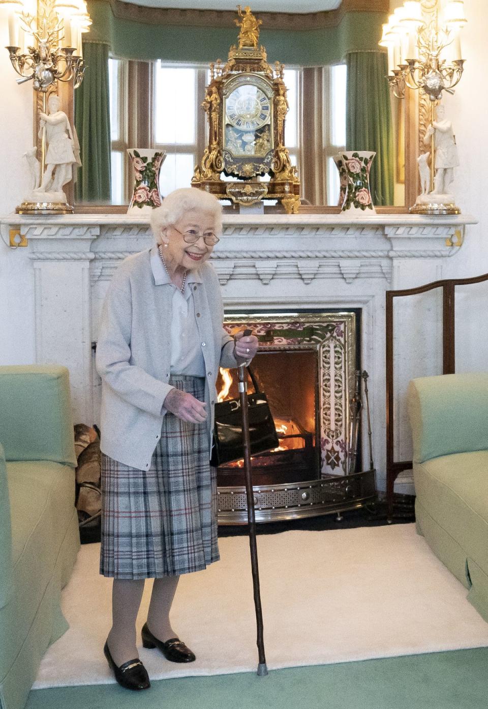 Concerns were raised for Queen Elizabeth II when she was seen with a walking stick in a rare appearance before her death (PA)