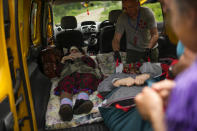 Women are evacuated by volunteers of Vostok SOS charitable organisation in Kramatorsk, eastern Ukraine, Thursday, May 26, 2022. Residents in villages and towns near the front line continue to flee as fighting rages in eastern Ukraine. (AP Photo/Francisco Seco)