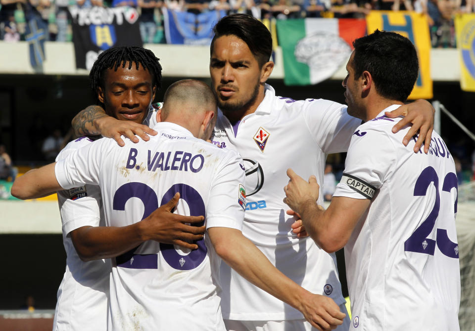 Fiorentina's Borja Valero, back to camera, of Spain, celebrates with teammates after scoring during a Serie A soccer match against Hellas Verona at Bentegodi stadium in Verona, Italy, Sunday, April 13, 2014. (AP Photo/Felice Calabro')