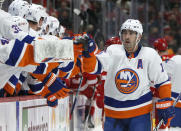 New York Islanders right wing Cal Clutterbuck (15) celebrates with teammates after scoring against the Detroit Red Wings during the first period of an NHL hockey game Saturday, Dec. 4, 2021, in Detroit. (AP Photo/Duane Burleson)